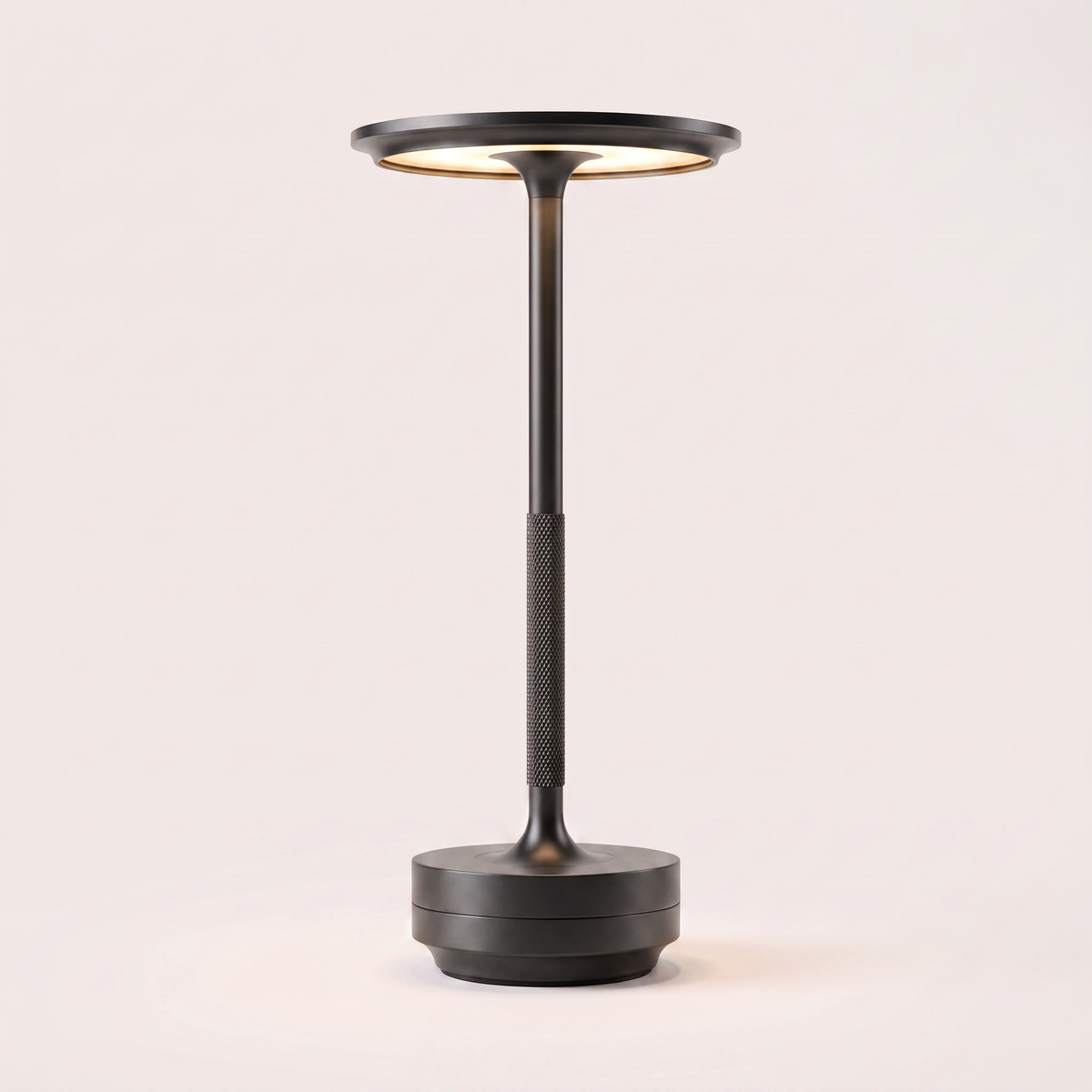 Eclara Ilumina cordless table lamp in matte black, flat disc head with warm LED, knurled stem and stepped base