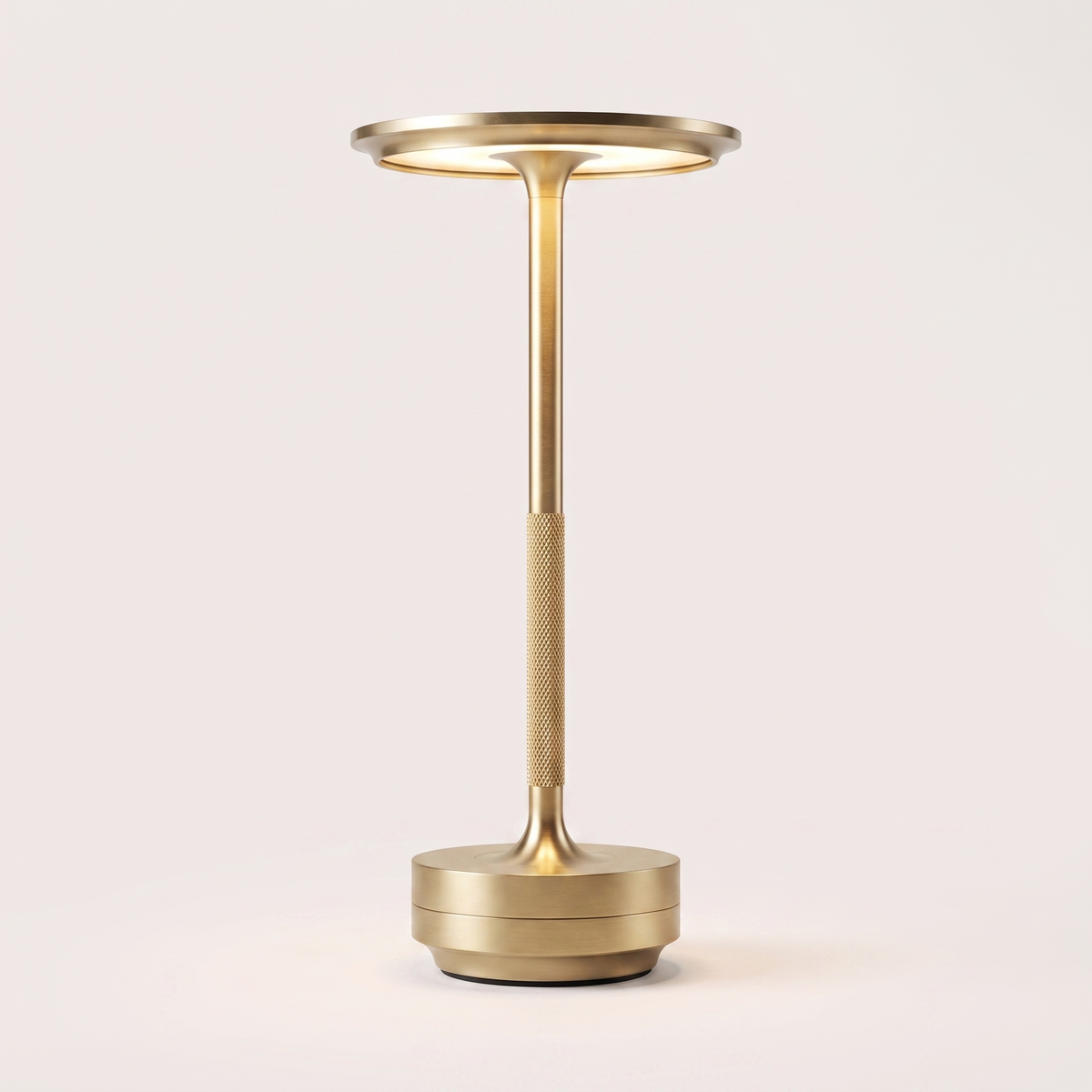 Eclara Ilumina cordless table lamp in brushed gold, flat disc head with warm LED, knurled stem and stepped base