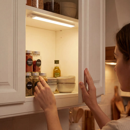 Rechargeable ECLARA LED light installed inside a kitchen cupboard, illuminating the interior
