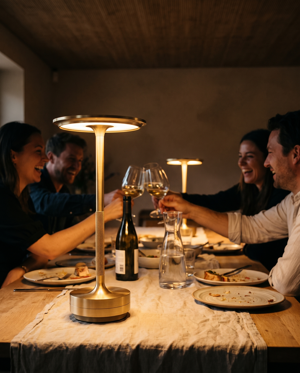 Eclara Ilumina cordless lamps lighting a long shared table during a private dining celebration